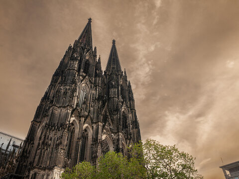 Cologne Cathedral seen from below with blue sky. Cologne Cathedral, or Kolner Dom, is the main landmark of Cologne and a catholic church in Germany.
