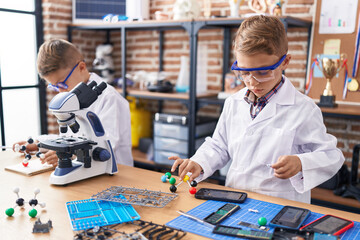 Adorable boys students playing with molecules toy at laboratory classroom