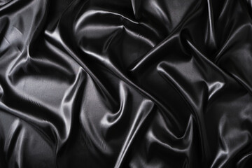 Silk fabric, abstract wavy black satin fabric background.