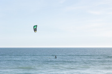 A person kitesurfing in the sea