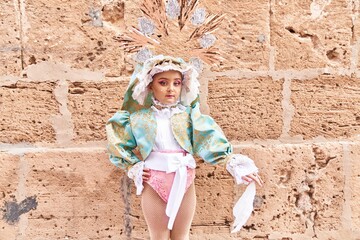 Adorable child wearing virgion custom over brick background