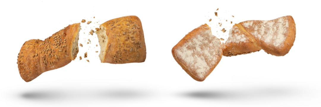 Two loaves of crispy bread isolated on white. Loaves of freshly baked crispy bread are broken in half with crumbs flying in all directions at the break. Top and bottom view. Fresh baking concept.