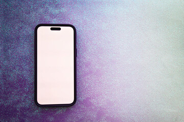 Overhead view of a mobile phone with a blank white screen on a purple gradient background