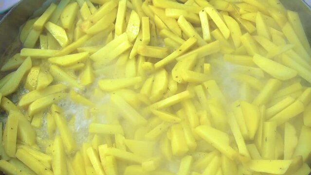 Potatoes are fried on a disk in nature