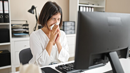 Young beautiful hispanic woman business worker using computer sneezing at office
