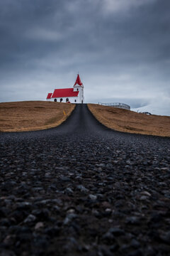 Straight road leading to Ingjaldsholskirkja Church near Hellissandur, Snaefellsnes Peninsula, Iceland