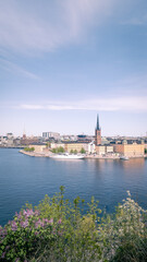 Fototapeta na wymiar Panoramic view of Riddarholmen and Riddarholmskyrkan and Stockholm old town on warm spring day in Sweden