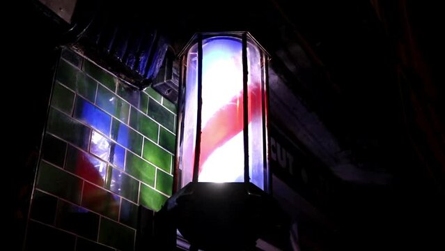 Unusual Barber Shop Pole Rotating at Night with Reflection