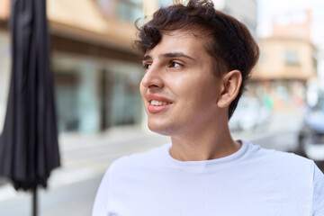 Obraz premium Non binary man smiling confident looking to the side at street