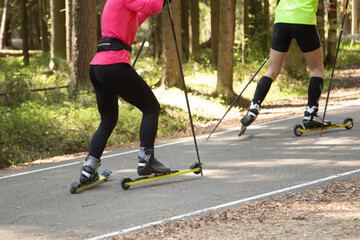 Roller skis.A woman runs in a summer park on roller skis.Cross country skilling.