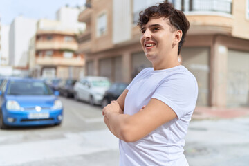 Fototapeta premium Non binary man standing with arms crossed gesture at street