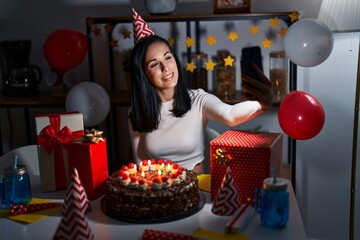 Young caucasian woman celebrating birthday making selfie by smartphone at home
