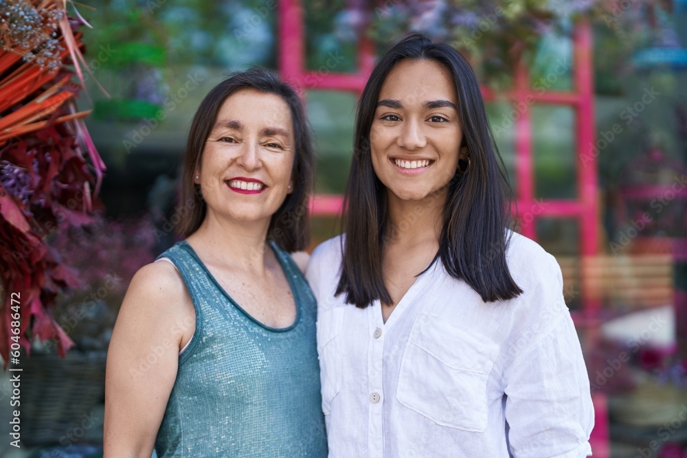 Wall mural two women mother and daughter smiling confident hugging each other at street