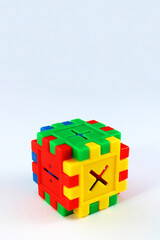 Colorful cube with addition, subtraction and multiplication signs, puzzle game