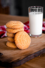 Homemade cakes. Homemade biscuits with a glass of milk on a wooden board