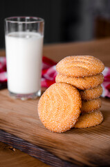 Homemade biscuits with a glass of milk on a wooden board. Homemade cakes