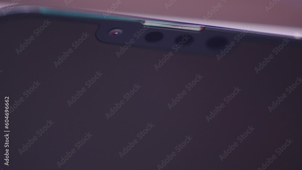 Poster extreme close up of a smartphone screen with front cameras. action. light flared on smartphone displ