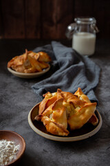 Baked little pies piroshki on dark grey background 