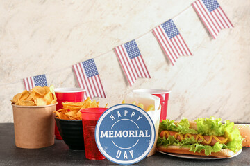 Fototapeta premium Card with text HAPPY MEMORIAL DAY, tasty dishes and drinks on dark table