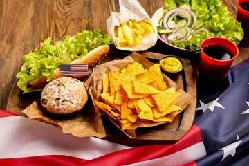 Composition with tasty dishes, drink for Memorial Day celebration and American flag on wooden background