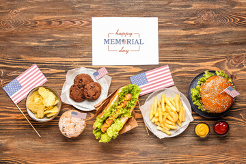 Card with text HAPPY MEMORIAL DAY and tasty dishes on wooden background