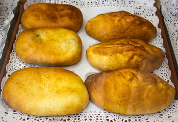 Fried baked pies. Street food food. Flour products, stuffed on a tray.