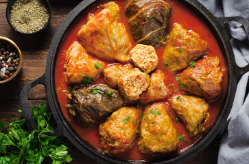 Cabbage Rolls with Ground Meat, Rice and Vegetables also known as Sarma, Golubtsy, Dolma on Rustic Wooden Background