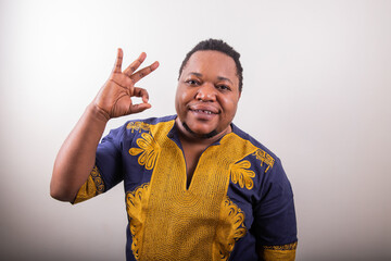 Trans man making an 'Okay' hand sign, isolated person on white background