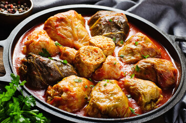 Cabbage Rolls with Ground Meat, Rice and Vegetables also known as Sarma, Golubtsy, Dolma on Rustic Wooden Background