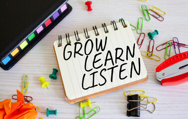 Grow Learn Listen symbol. Concept words Grow Learn Listen on white notebook. Beautiful wooden background. Business and Grow Learn Listen concept. Copy space