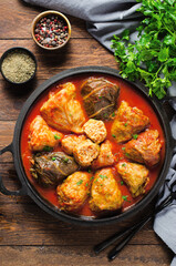 Cabbage Rolls with Ground Meat, Rice and Vegetables also known as Sarma, Golubtsy, Dolma on Rustic Wooden Background