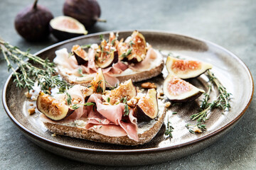 Tasty bruschetta with cream cheese, proscuitto  and figs for breakfast time