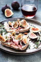Tasty bruschetta with cream cheese, proscuitto  and figs for breakfast time