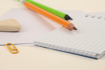 Empty copy space Blank paper note and pencil on beige neutral table. Art home office desk workspace.