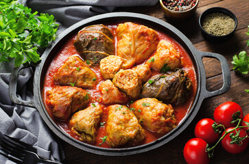 Cabbage Rolls with Ground Meat, Rice and Vegetables also known as Sarma, Golubtsy, Dolma on Rustic Wooden Background