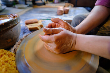ceramics, workshop, ceramic art concept - close-up of man's hands forming a new vessel, man's...