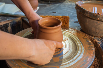 ceramics, workshop, ceramic art concept - close-up of man's hands forming a new vessel, man's...