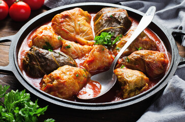 Cabbage Rolls with Ground Meat, Rice and Vegetables also known as Sarma, Golubtsy, Dolma on Rustic Wooden Background