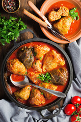 Cabbage Rolls with Ground Meat, Rice and Vegetables also known as Sarma, Golubtsy, Dolma on Rustic Wooden Background
