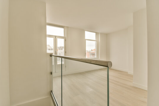 an empty room with wood floors and glass railings on the bottom, looking out to the city skyline below