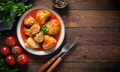 Cabbage Rolls with Ground Meat, Rice and Vegetables also known as Sarma, Golubtsy, Dolma on Rustic Wooden Background