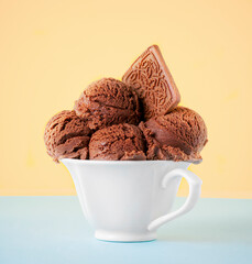 
Chocolate ice cream on a bright background in a white cup