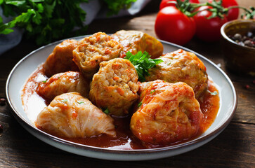 Cabbage Rolls with Ground Meat, Rice and Vegetables also known as Sarma, Golubtsy, Dolma on Rustic Wooden Background