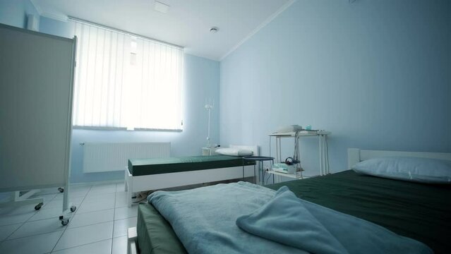 A hospital room equipped with two beds, ready to accommodate patients and provide necessary medical care.