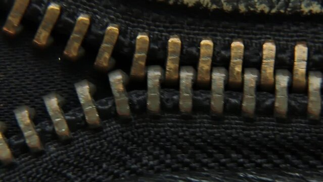Close-up of a vintage metal zipper on a leather jacket. 