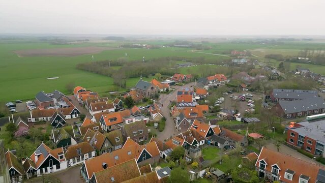This aerial drone video shows the small village of Oosterend in Texel. Texel is one of the islands in the wadden sea. Oosterend is mostly residential area and there is an old church in the center.
