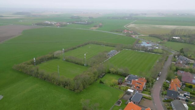 This aerial drone video shows the small village of Oosterend in Texel. Texel is one of the islands in the wadden sea. Oosterend is mostly residential area and there is an old church in the center.