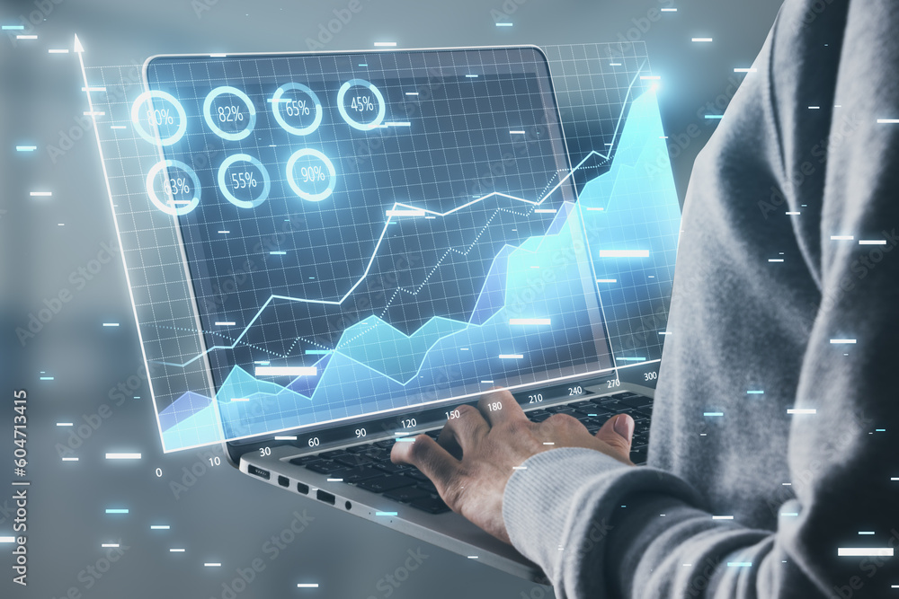 Poster close up of hands using laptop with digital business chart hologram on blurry background. financial 
