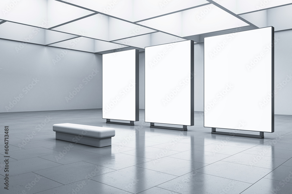 Poster perspective view on three blank white glowing screens with space for your advertising grey wall back