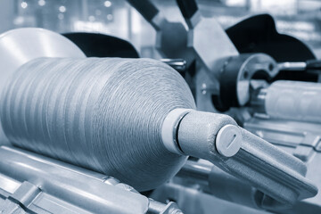 Obraz na płótnie Canvas synthetic textile thread, thread at industrial weaving manufacturing machine, textile fabric production industrial concept background